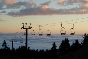Chairlifts Rise Above Clouds